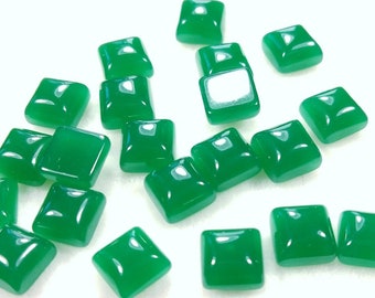 May include: A collection of 18 green square-shaped cabochons. The cabochons are smooth and have a glossy finish.