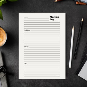 May include: A cream-colored Meeting Log notepad with lines for notes, featuring the text "Issues," "Decisions," "Actions," and "Q&A." The notepad is on a dark surface, with pencils, a coffee cup, and a notebook nearby.