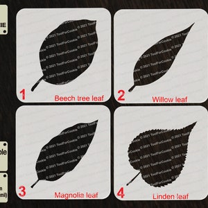 May include: Four white stencils with black leaf designs: Beech tree, Willow, Magnolia, and Linden. Each stencil is labeled with the leaf type and a number. The stencils are for cookie decorating and are made of APET plastic, 1 mm thick.