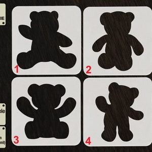 May include: Four reusable cookie stencils featuring different teddy bear designs. The stencils are made of 1000 micron APET plastic, which is 1 mm thick. The stencils are labeled with numbers 1 through 4.