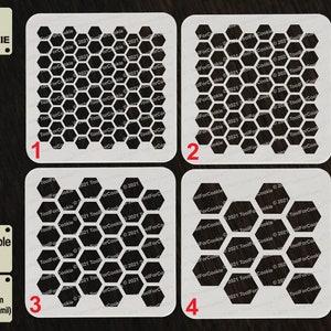 May include: Four white reusable stencils with honeycomb patterns. The stencils are made of 1000 micron APET plastic and are numbered 1 through 4.