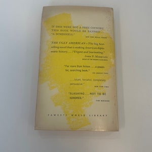 May include: The back cover of "The Ugly American" book. The cover is off-white with yellow accents. Text includes quotes from various publications and the Fawcett World Library logo. The book's title is prominently displayed.