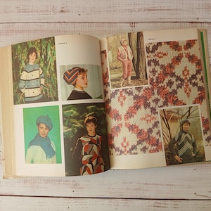 May include: An open instructional knitting book featuring multiple pages of color photographs. The images display various knitted garments including sweaters, scarves, and hats with geometric and abstract patterns, alongside detailed close-up swatches.