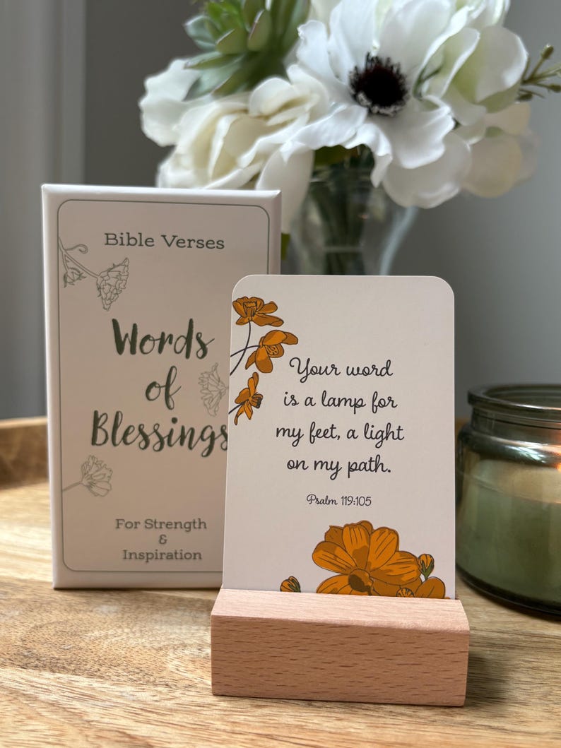 May include: A set of "Words of Blessings" Bible verse cards with a wooden card holder. The cards feature floral illustrations and the text "Your word is a lamp for my feet, a light on my path. Psalm 119:105."