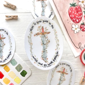 May include: A white oval sticker with a sword surrounded by flowers and vines. The text "There is some good in this world, and it's worth fighting for." - J.R.R. Tolkien is written around the sword.