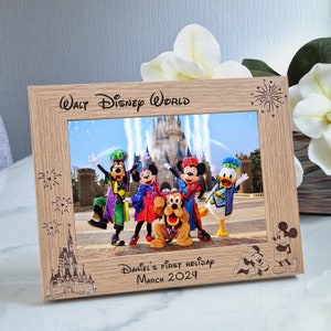 May include: A wooden photo frame with a picture of Mickey Mouse and his friends at Walt Disney World. The frame is engraved with "Walt Disney World" and "Daniel's First Holiday March 2024".