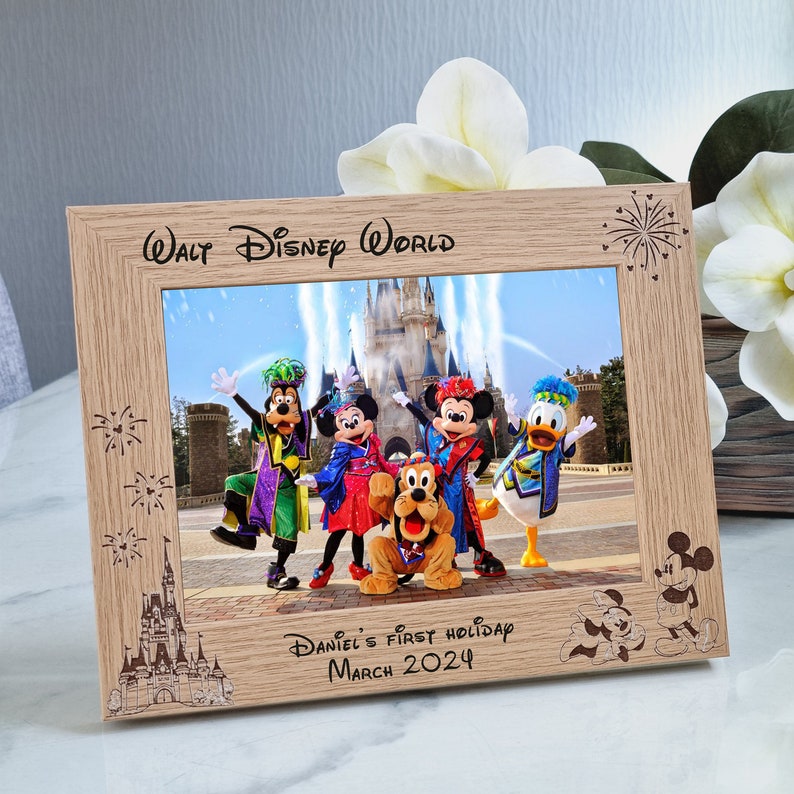 May include: A wooden photo frame with a picture of Mickey Mouse and his friends at Walt Disney World. The frame is engraved with "Walt Disney World" and "Daniel's First Holiday March 2024".