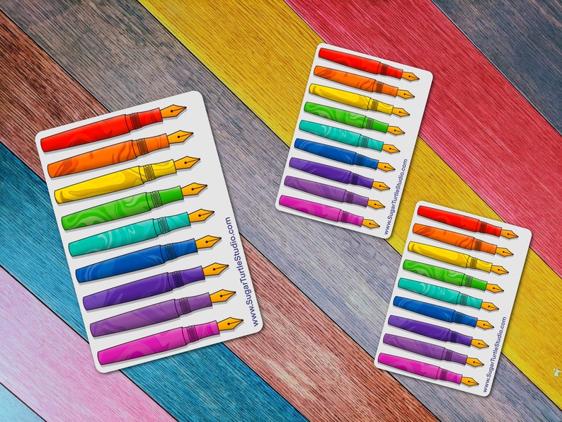 May include: A sheet of rainbow colored fountain pen stickers with a swirl pattern. The stickers are on a white background and have the website address "www.SugarTurtleStudio.com" printed on the bottom right corner.