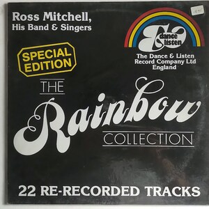 Könnte beinhalten: Ein schwarzes Vinyl-Albumcover mit einem Regenbogen-Design und dem Text "The Rainbow Collection" in Weiß. Das Album ist von Ross Mitchell, His Band & Singers und enthält 22 neu aufgenommene Tracks. Das Cover enthält auch ein Logo für "The Dance & Listen Record Company Ltd England".