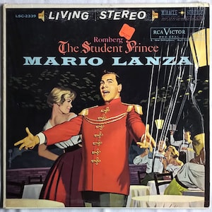 May include: A vintage vinyl record cover featuring Mario Lanza in a red military uniform singing. The album cover is for "The Student Prince" by Romberg. The cover is in a living stereo format and is a RCA Victor Red Seal record.