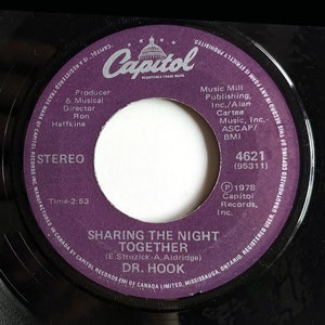 May include: A purple vinyl record with the title "Sharing the Night Together" by Dr. Hook. The record label is Capitol Records and the song was written by E. Struzick and A. Aldridge. The record number is 4621 (95311).