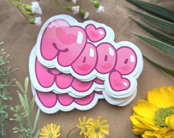 May include: A stack of pink and white stickers with the word "MOOD" written in a bubble font. The stickers have a glossy finish and are decorated with hearts.