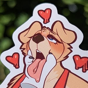 May include: A die-cut sticker featuring a tan anthropomorphic dog character with a red shirt, mouth open with tongue out, and three red dripping heart icons surrounding the head. The illustration uses bold dark outlines and a flat color palette.
