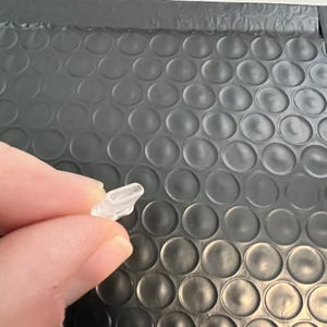 May include: A clear plastic earbud tip for headphones.