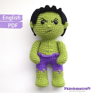 May include: Green crocheted Hulk amigurumi doll with black hair, purple trousers, and a grumpy expression. The doll is standing on a white background. The text "English PDF" is in the top left corner of the image.