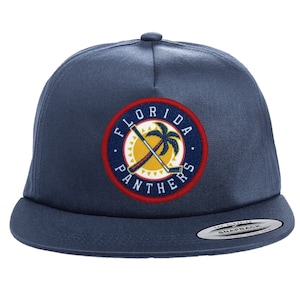 May include: A navy blue baseball cap with a Florida Panthers logo featuring a palm tree and hockey sticks. The logo is embroidered in red, yellow, and blue.