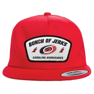 May include: Red baseball cap with a white patch that says "Bunch of Jerks" and "Carolina Hurricanes".