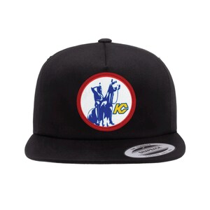 May include: Black baseball cap with a red, white, and blue embroidered patch featuring a rider on a horse and the letters "KC".