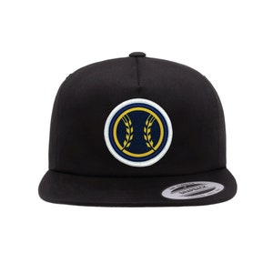 May include: Black baseball cap with a white and blue embroidered patch featuring a baseball with wheat stalks. The patch has a yellow outline.