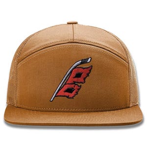 May include: A brown baseball cap with a mesh back and a flat brim. The front of the cap features an embroidered logo in red, black, and white. The cap is a classic style, suitable for casual wear.