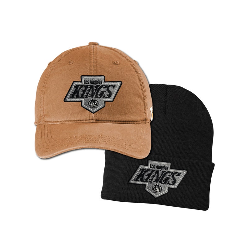 K&ouml;nnte beinhalten: Zwei H&uuml;te, einer braun und einer schwarz, beide mit dem Logo der Los Angeles Kings mit dem Text "Los Angeles Kings" und einer Krone.