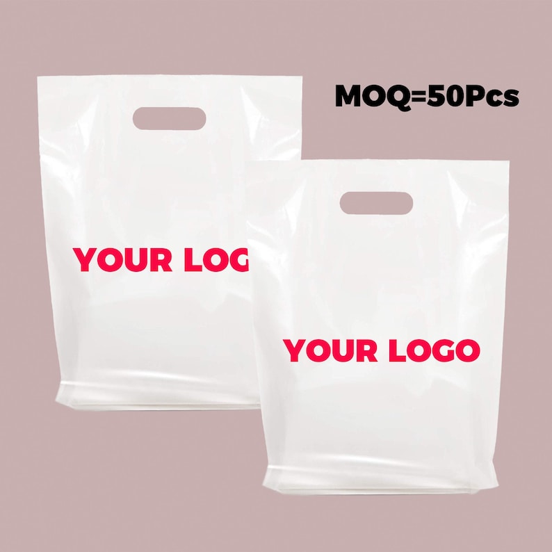May include: Two white plastic shopping bags with cut-out handles. The bags have the text "YOUR LOGO" printed in red on the front.