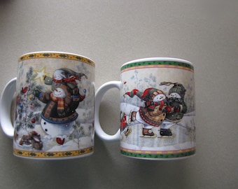Set of 2 Vintage snowman design, each has a different scene by Janete Stevers, 12 oz
