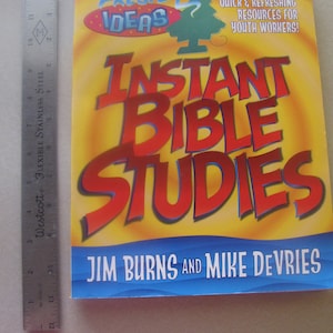 May include: A book titled "Instant Bible Studies" with a yellow cover featuring the words "Fresh Ideas" and a cartoon tree. The book is by Jim Burns and Mike DeVries.