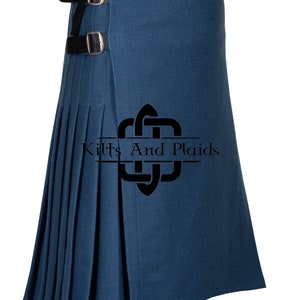 May include: A dark blue kilt with a black leather strap and buckle. The kilt has pleats and is made of a thick fabric. The kilt is a traditional Scottish garment.