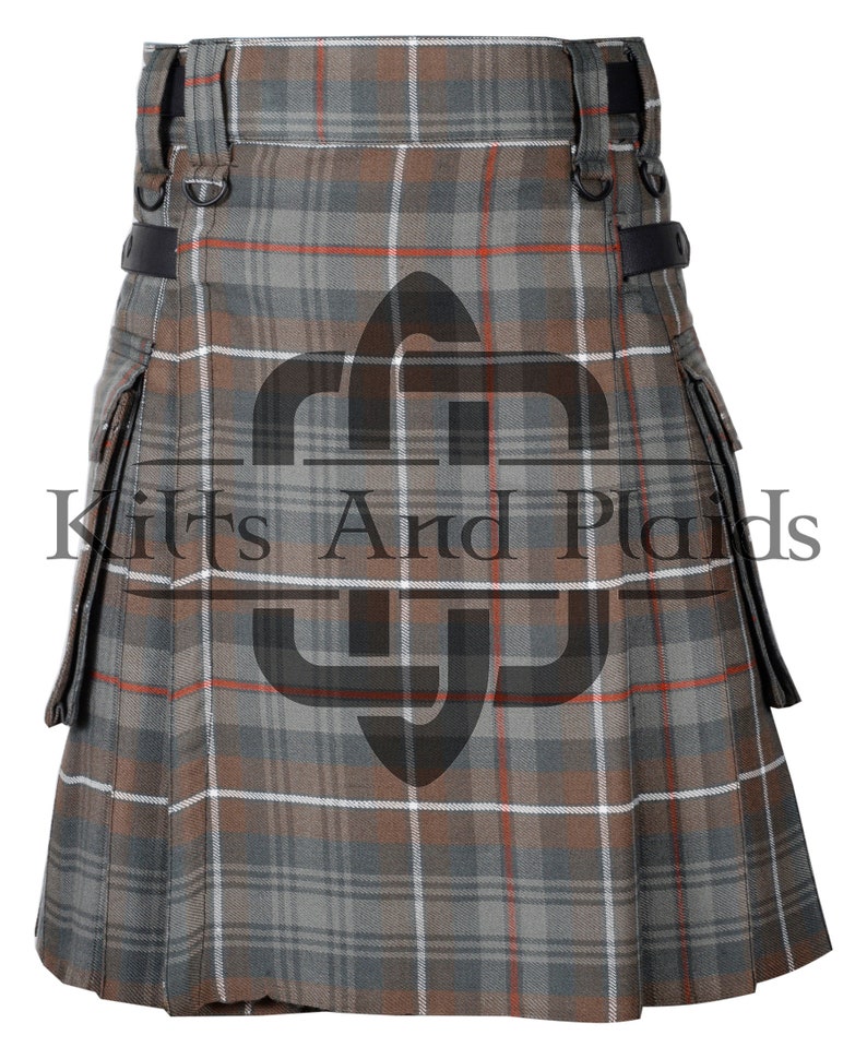 May include: A brown, grey and white tartan kilt with a leather strap and buckle detail. The kilt has two large cargo pockets on the sides.