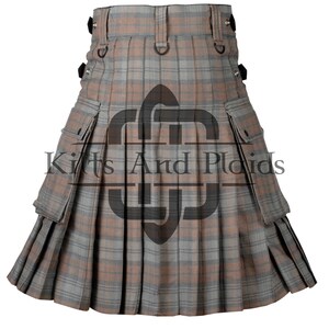 May include: A brown and grey utility kilt with multiple pockets and a plaid pattern. The kilt has a black buckle and strap closure.
