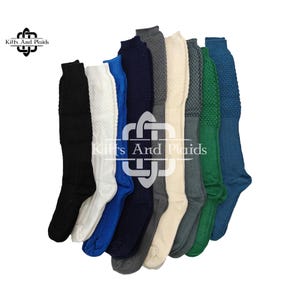 May include: A collection of knee-high socks in various colors, including black, white, blue, navy, gray, and green. The socks have a textured knit pattern on the upper portion and are displayed against a white background. The brand logo "Kilts And Plaids" is visible.