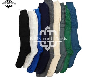 May include: A collection of knee-high socks in various colors, including black, white, blue, navy, gray, and green. The socks have a textured knit pattern on the upper portion and are displayed against a white background. The brand logo "Kilts And Plaids" is visible.