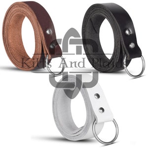 May include: Three leather straps in brown, black, and white, each rolled into a circle. Each strap has a metal ring attached with rivets. The straps are likely for crafting or accessories.