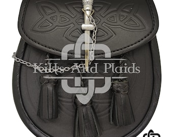 May include: Black leather sporran with embossed Celtic knot design on the flap. Features a silver cantle and chain, with three black leather tassels. The text "Kilts And Plaids" is visible.