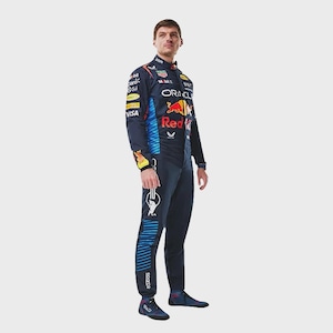 May include: A dark navy blue racing suit featuring multiple sponsor logos including Oracle, Red Bull, and Visa. The suit has bright blue horizontal stripes along the sides of the torso and legs, a high collar, and matching dark navy racing shoes.