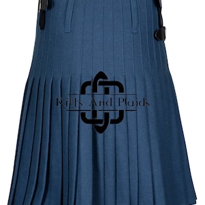 May include: A blue kilt with pleats and black buckles. The kilt has the text "Kilts And Plaids" printed on it.