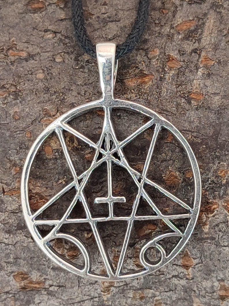 May include: A silver pendant necklace with a pentagram design. The pentagram is surrounded by a circle and has a cross in the center.
