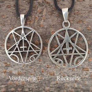 May include: A silver pendant with a geometric design featuring a five-pointed star and a cross. The pendant is shown from both the front and back. The back of the pendant is stamped with "925", indicating it is made of sterling silver.