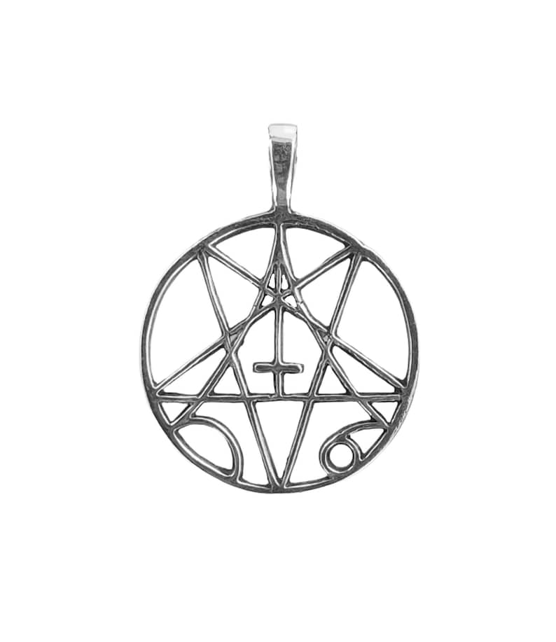 May include: A silver pendant featuring a pentagram with a cross inside, surrounded by a circle.