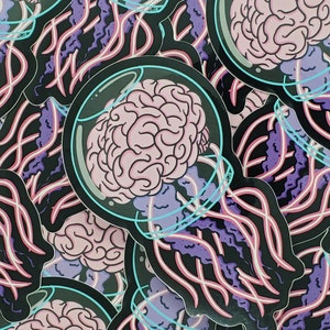 May include: A stack of stickers featuring a brain inside a glass jar with tentacles. The brain is pink and the tentacles are purple and black.