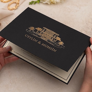 May include: A black invitation with gold lettering and a gold illustration of a building. The invitation is open, revealing a cream-colored interior with gold accents. The text "CEYLIN & MUHSIN" is visible.