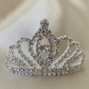 tiny rhinestone tiara on a beige background