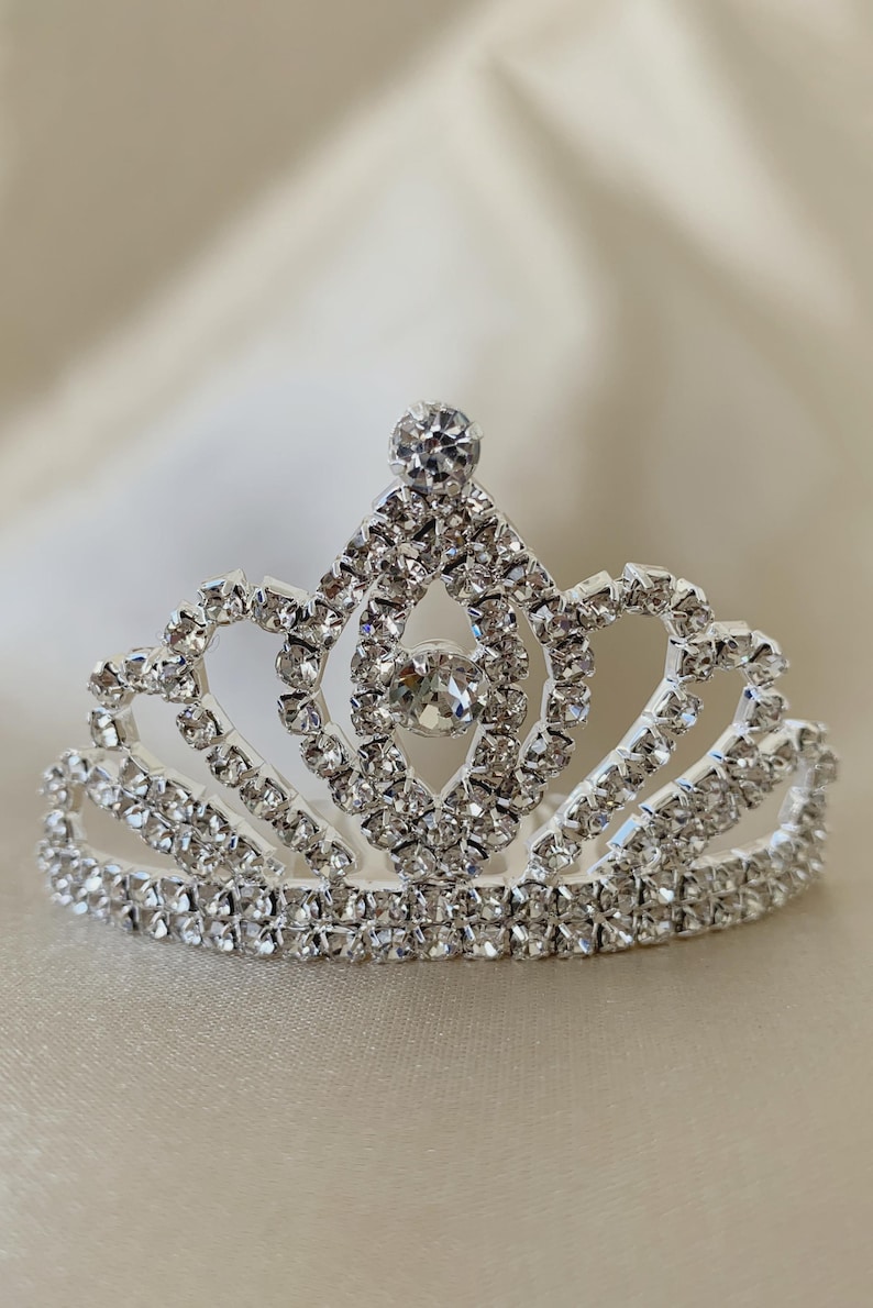 tiny rhinestone tiara on a beige background