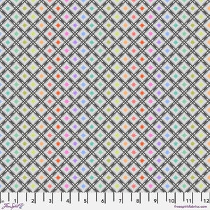 May include: Fabric featuring a repeating pattern of colourful starbursts in orange, pink, purple, blue, and green, set against a grey background. The design is arranged in a diamond grid with a dark grey outline. The fabric has a ruler along the bottom.