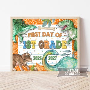 May include: A rectangular sign featuring watercolor illustrations of four dinosaurs, a bone, and autumn leaves. The text reads FIRST DAY OF 1ST GRADE with the years 2026 and 2027. The background has orange borders and a white center with blue lines.