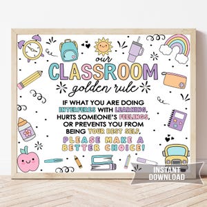 May include: A framed classroom poster with a light wood frame. The poster features colorful illustrations of school supplies and a rainbow. Text reads "Our Classroom Golden Rule" and a positive message about making good choices.