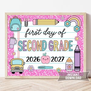 May include: A framed sign with a pink background and school-themed illustrations. The sign reads "first day of SECOND GRADE" with the years 2026 and 2027. Includes a backpack, pencil, rainbow, and other school-related graphics.