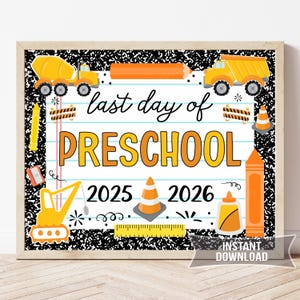Può includere: Una stampa incorniciata con uno sfondo maculato in bianco e nero. Il testo "last day of PRESCHOOL" è in arancione e giallo. La stampa include illustrazioni di veicoli da costruzione, matite e un righello. Vengono visualizzati anche gli anni 2025 e 2026.