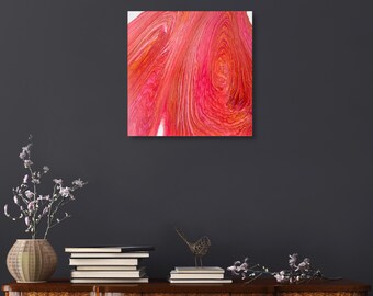 May include: Abstract painting with swirling red and orange colors. The painting has a textured look and is framed in a white frame.